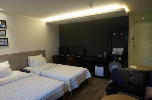 Postel nebo postele na pokoji v ubytování MU Hotel