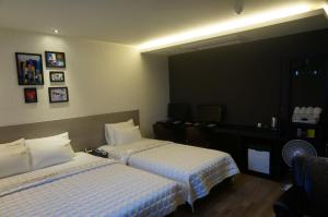 Postel nebo postele na pokoji v ubytování MU Hotel