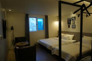 Postel nebo postele na pokoji v ubytování MU Hotel