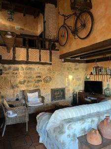 a bedroom with a bed and a bike on the wall at Casa Rural La Charolesa in Aguilera