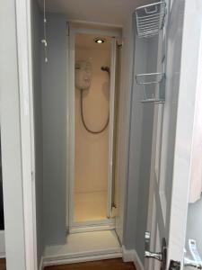a walk in shower in a bathroom with a shower at Pebbles & Prosecco in Brighton & Hove