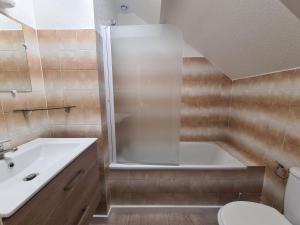 a bathroom with a tub and a toilet and a sink at Le Citrus in Excideuil +42 photos