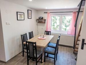 a dining room with a wooden table and chairs at Holiday Home Leisure Lounge & Pool by Interhome in Kvasiny +20 photos