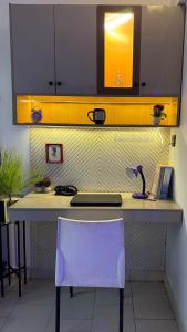 Una encimera de cocina con una silla blanca y un fregadero. en Luxury beach studio, en Karachi