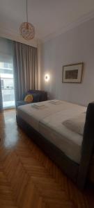 a bedroom with a large bed and a window at FirstLineSkg3 Moodsolutions Living in Thessaloniki
