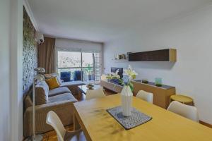 a living room with a table and a couch at 3 bedroom Huge apartament near the beach in Sant Adria de Besos