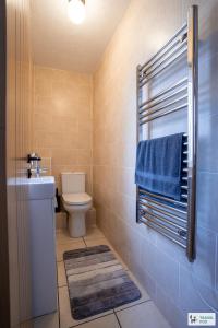 a bathroom with a toilet and a blue towel at Ann's Home Near Alton Towers in Rocester
