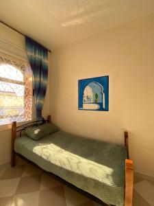 a bedroom with a bed and a window at Ben House in Chefchaouene +5 photos