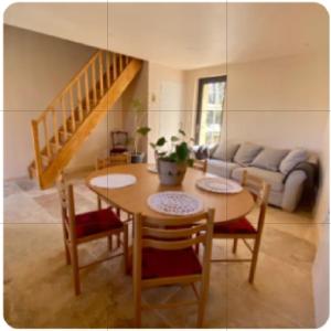 a living room with a table and chairs and a couch at Chambre du saule in Fouronnes