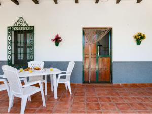 a dining room with a table and chairs and a door at Holiday Home Villa Chirimoya by Interhome in Torrenueva