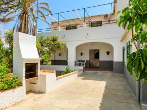 an exterior view of a white house with a porch at Holiday Home Villa Chirimoya by Interhome in Torrenueva