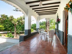 an outdoor dining area with a table and chairs at Holiday Home Villa Chirimoya by Interhome in Torrenueva +24 photos