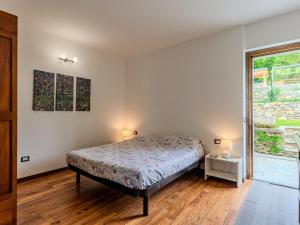 a bedroom with a bed and a window at Apartment Beppe by Interhome in Peglio