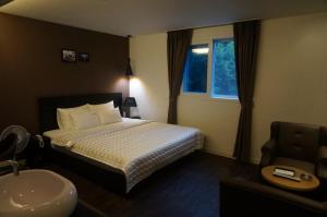 Postel nebo postele na pokoji v ubytování MU Hotel