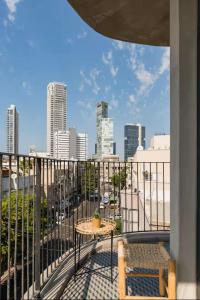 a balcony with a table and a view of a city at AYA Boutique Aparthotel in Tel Aviv +131 photos