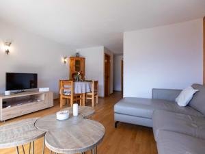 a living room with a couch and a table at Apartment Vermont 8 by Interhome in Villars-sur-Ollon