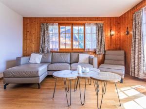 a living room with a couch and a table at Apartment Vermont 8 by Interhome in Villars-sur-Ollon