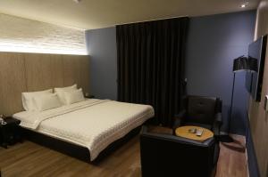 Postel nebo postele na pokoji v ubytování MU Hotel