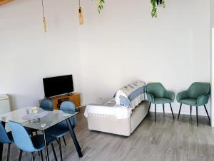 a living room with a couch and chairs and a table at Quintal do Olival- Um refúgio na Natureza in Lousã