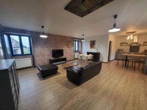a living room with a couch and a table at Maison rénové in Sainte-Gemme