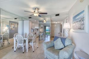 a living room with a couch and a table and chairs at Beach Dont My Vibe in Ormond Beach