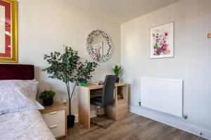 ein Schlafzimmer mit einem Schreibtisch mit einem Stuhl und einem Spiegel in der Unterkunft Vista Verde - Luxury City Penthouse 2BR - Sleeps up to 6 - Parking in Birmingham + 57 Fotos