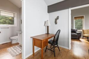 a home office with a desk and a chair at Serene Waterfront Escape On Private Lane in Meaford +32 photos