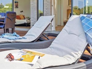 two wicker chairs sitting on a patio at Holiday Home Troels - 945m from the sea by Interhome in Hornbæk