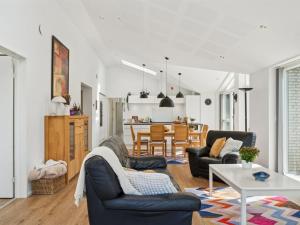 a living room with two chairs and a table at Holiday Home Troels - 945m from the sea by Interhome in Hornbæk +18 photos