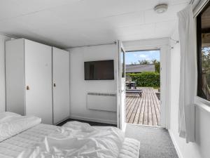 a bedroom with a bed and a sliding glass door at Holiday Home Adia - 500m from the sea by Interhome in Hejlsminde