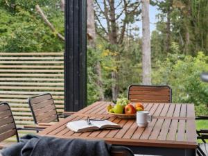 una mesa de madera con un bol de fruta y un libro en Holiday Home Aggi - 850m from the sea by Interhome, en Kårup 27 fotos más
