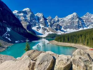 a view of a mountain lake with snow covered mountains at Newly Built 2BR and 2BA MtnView Retreat in DT Canmore in Canmore