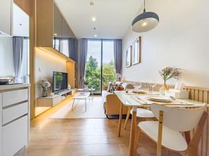 Una cocina y una sala de estar con mesa y sillas. en Asoke Luxury High Rise - Steps to BTS and MRT - WiFi, en Makkasan