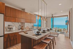a kitchen with a large island with stools in it at Dream Sayulita Penthouse in Sayulita