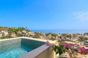 a swimming pool on top of a building with the ocean at Dream Sayulita Penthouse in Sayulita