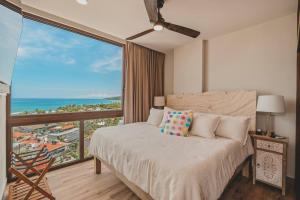 a bedroom with a bed and a large window at Dream Sayulita Penthouse in Sayulita +60 photos