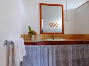 a bathroom with a sink and a mirror at Le Macoua Guest House in Nouvelle Découverte +39 photos