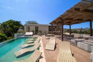 a swimming pool with chaise lounge chairs and a patio at Dream Sayulita Penthouse in Sayulita