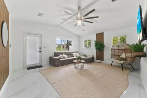 a living room with a couch and a ceiling fan at Casa Agape Waterfront HotTub 15 min to Beach in Hollywood
