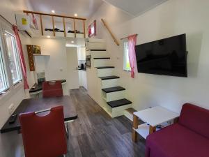 a small living room with a couch and a table at Holiday Home -2 by Interhome in Stuer