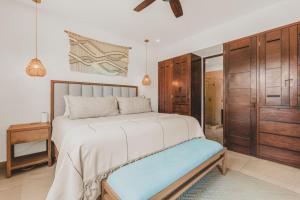 a bedroom with a large bed with a blue bench at Casa De Vigil Beachfront Oasis Ocean Views Pool in San Francisco +43 photos