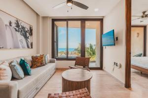 a living room with a couch and a table at Limited Time Offer Luxe 2 BR with Plunge Pool in Sayulita