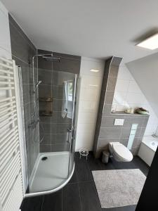 a bathroom with a shower and a toilet at Haus Auszeit in Cremlingen +6 photos