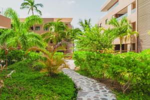 a walkway through a garden in front of a building at Casa Armada Beachfront Condo with Pool in San Francisco