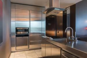 a kitchen with a stainless steel refrigerator and a sink at Vegas High Rise Condo w 2 Balconies w Resort in Las Vegas