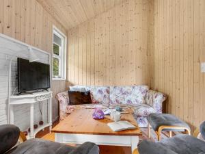 a living room with a couch and a table at Holiday Home Aleth - 800m from the sea by Interhome in Gedesby