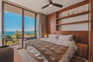 a bedroom with a bed and a large window at Elite 2BR 2BA Ocean Views Rooftop Pool in Sayulita +84 photos