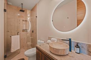 a bathroom with a sink and a toilet and a mirror at Chill in the tropics with style in Sayulita +35 photos