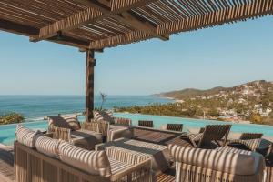a deck with chairs and a view of the ocean at Chill in the tropics with style in Sayulita
