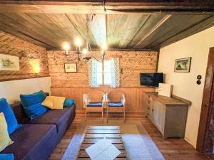 a living room with a couch and a tv at Chalet Schipplbadstube by Interhome in Annaberg im Lammertal +28 photos